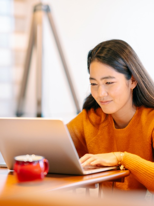 woman smiling at laptop screen